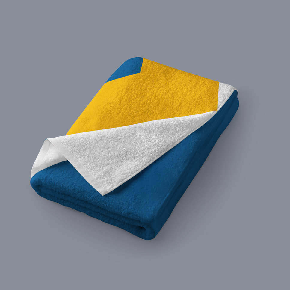 A beach towel, folded, and printed with the Unity Flag design